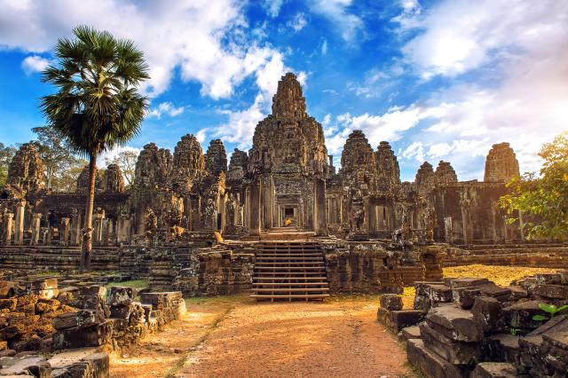 Ancient stone faces at sunset of Bayon temple, Angkor Wat, Siam